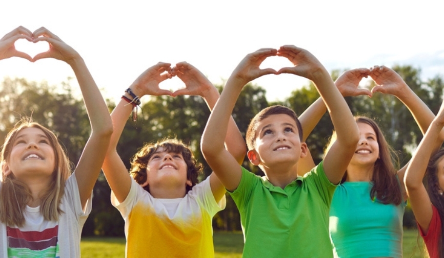 Healthy children making heart symbol with their hands