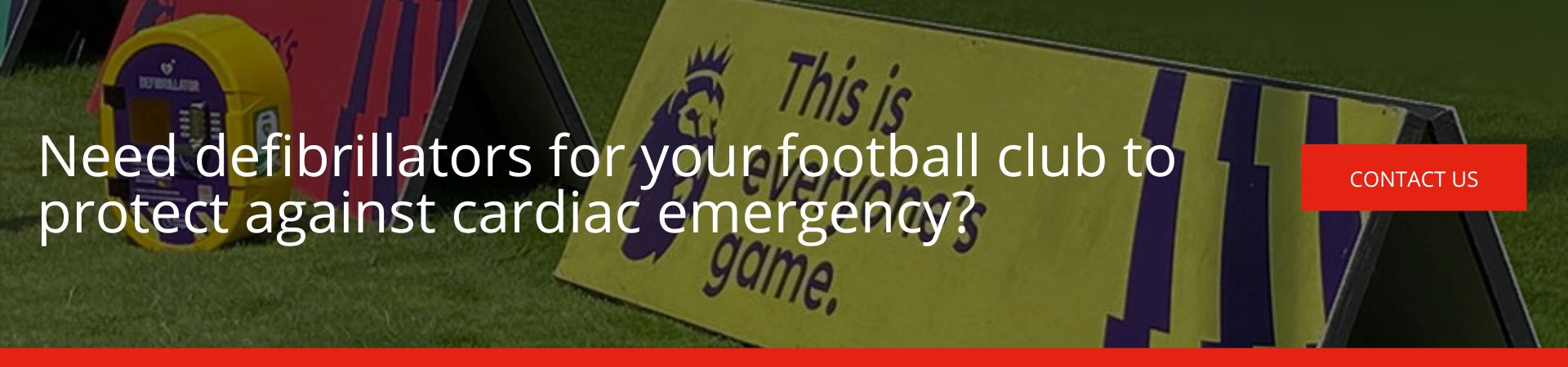 Need defibrillators for your football club to protect against cardiac emergency: A banner advertisement over a football pitch background, featuring a yellow defibrillator cabinet and a Premier League "This is everyone's game" sign, with a red "Contact Us" button.