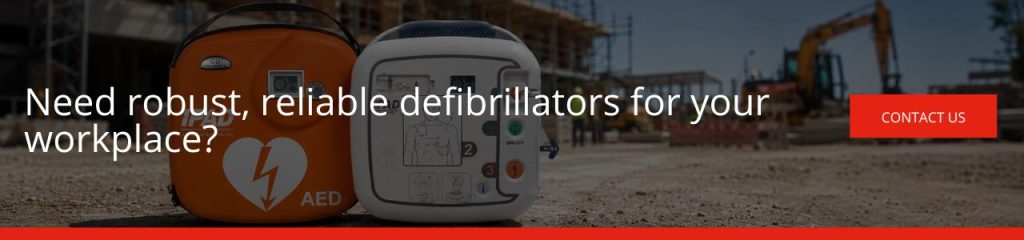 Need robust reliable defibrillators for your workplace Banner with the text "Need robust, reliable defibrillators for your workplace?" showing two defibrillator units in front of a blurred construction site, with a "Contact us" button.