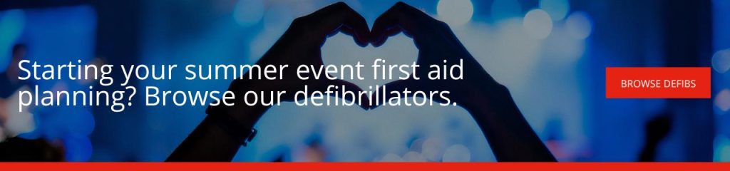 Starting your summer event first aid planning Browse our defibrillators Banner with the text "Starting your summer event first aid planning? Browse our defibrillators" over a silhouette of two hands forming a heart shape against blue festival lighting, with a "Browse defibs" button.